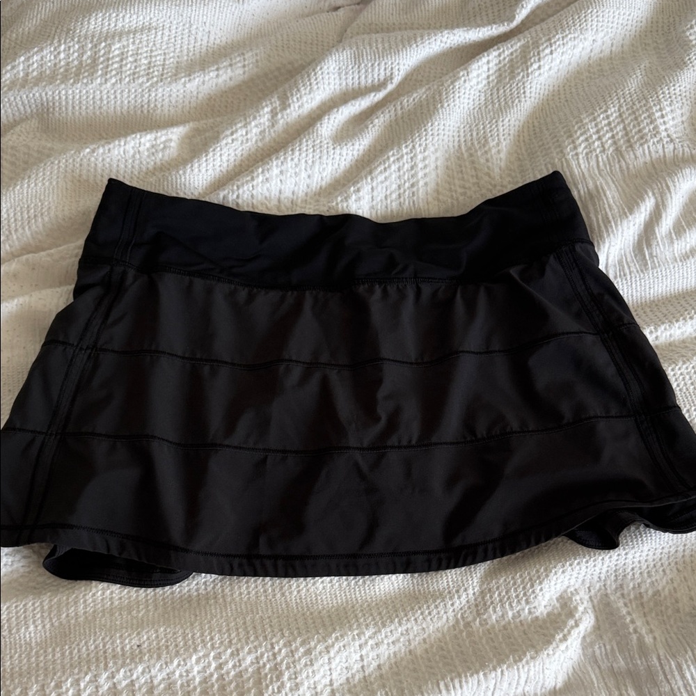 Black lululemon tennis skirt with built in shorts, pockets, and zipper pouch